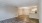 a room with a wood floor and white walls