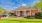 a house with a lawn and cars