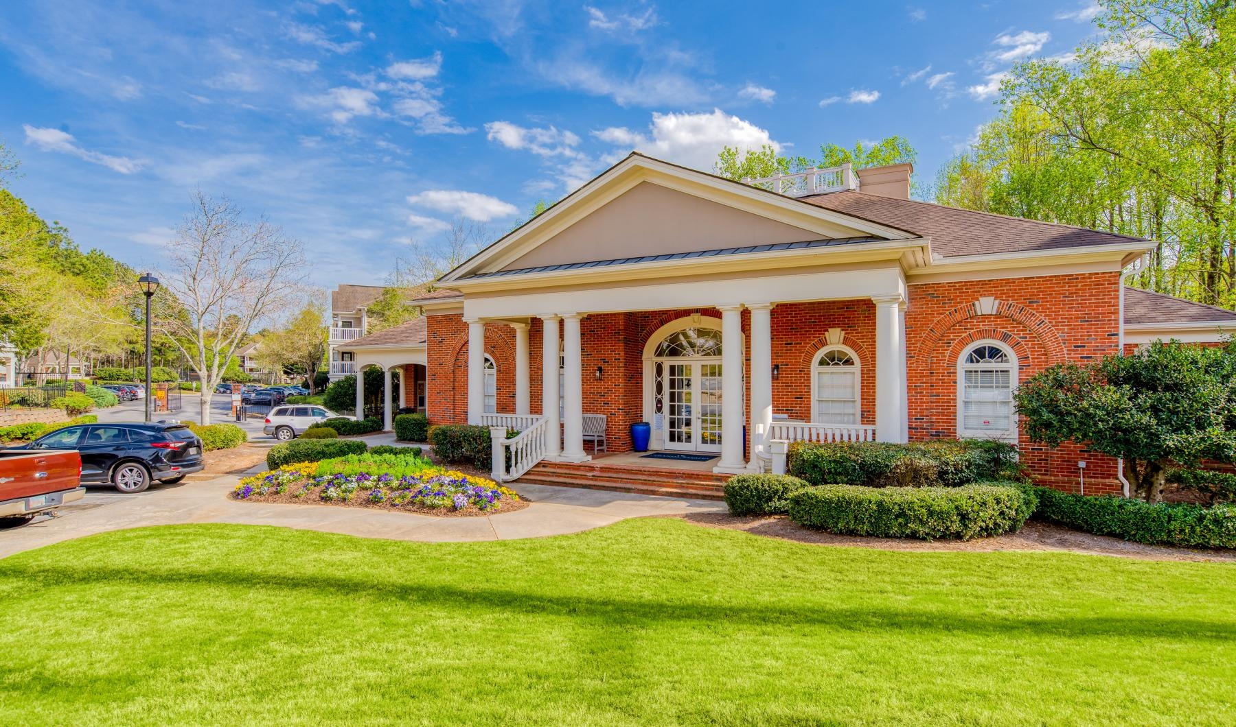 Settle into comfort at Veranda Estates a house with a lawn and cars