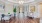 a room with a wood floor and a table with chairs and a chandelier